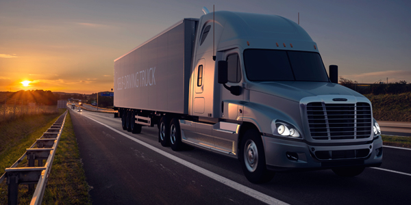 Truck on the highway with the sunset in background