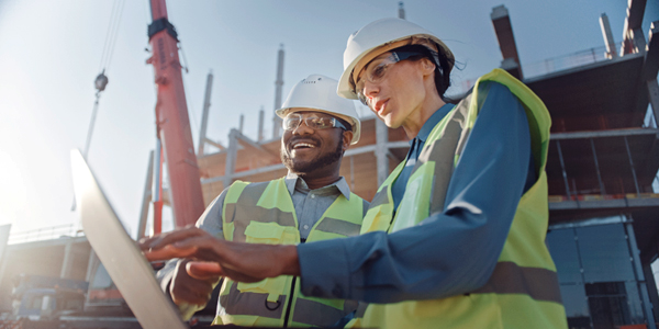 construction workers looking at blueprints