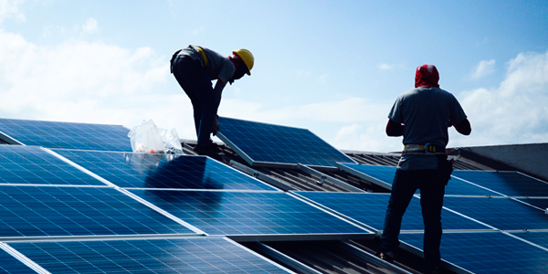 construction workers installing solar panels