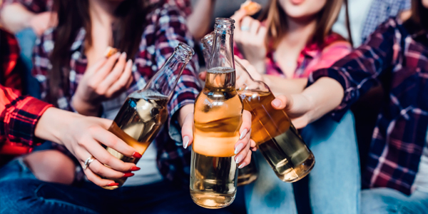 friends clinking beer bottles together