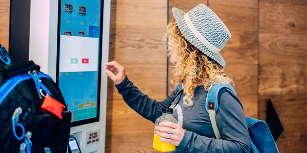 Customer using automated food ordering machine