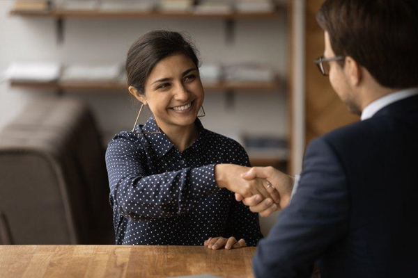 Manager shaking hand of newly-hired employee - QSR