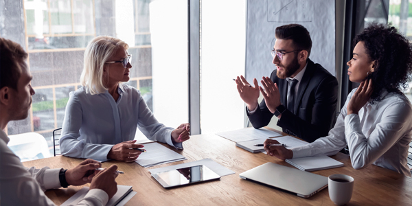 Professionals sitting around a table conducting a meeting