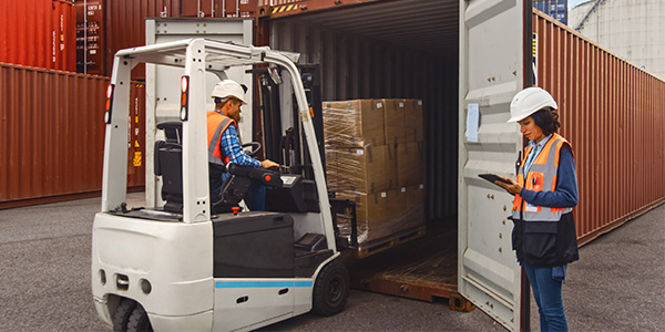 Forklift driver emptying a cargo bin