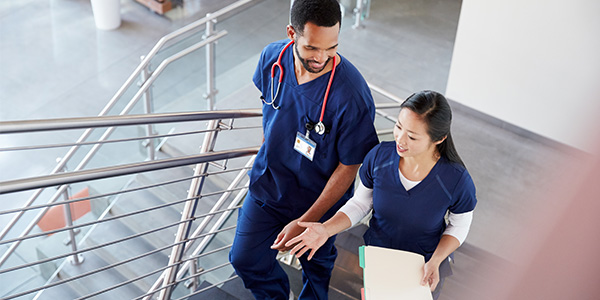 Two Nurses chatting while walking to next job