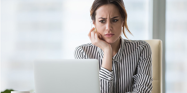 woman with laptop skeptical about business email compromise