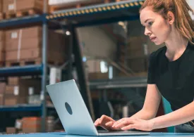 Warehouse manager working on a laptop