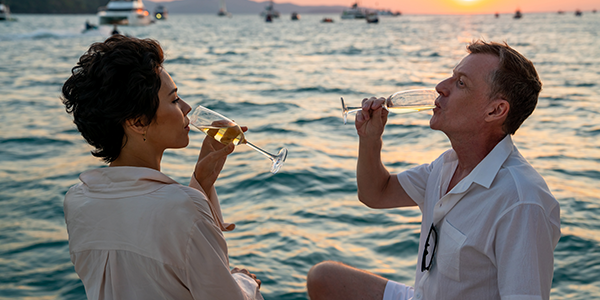 Couple shares a drink on the beach